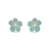 blue enamel and gold flower earrings with diamond centers held in a hand